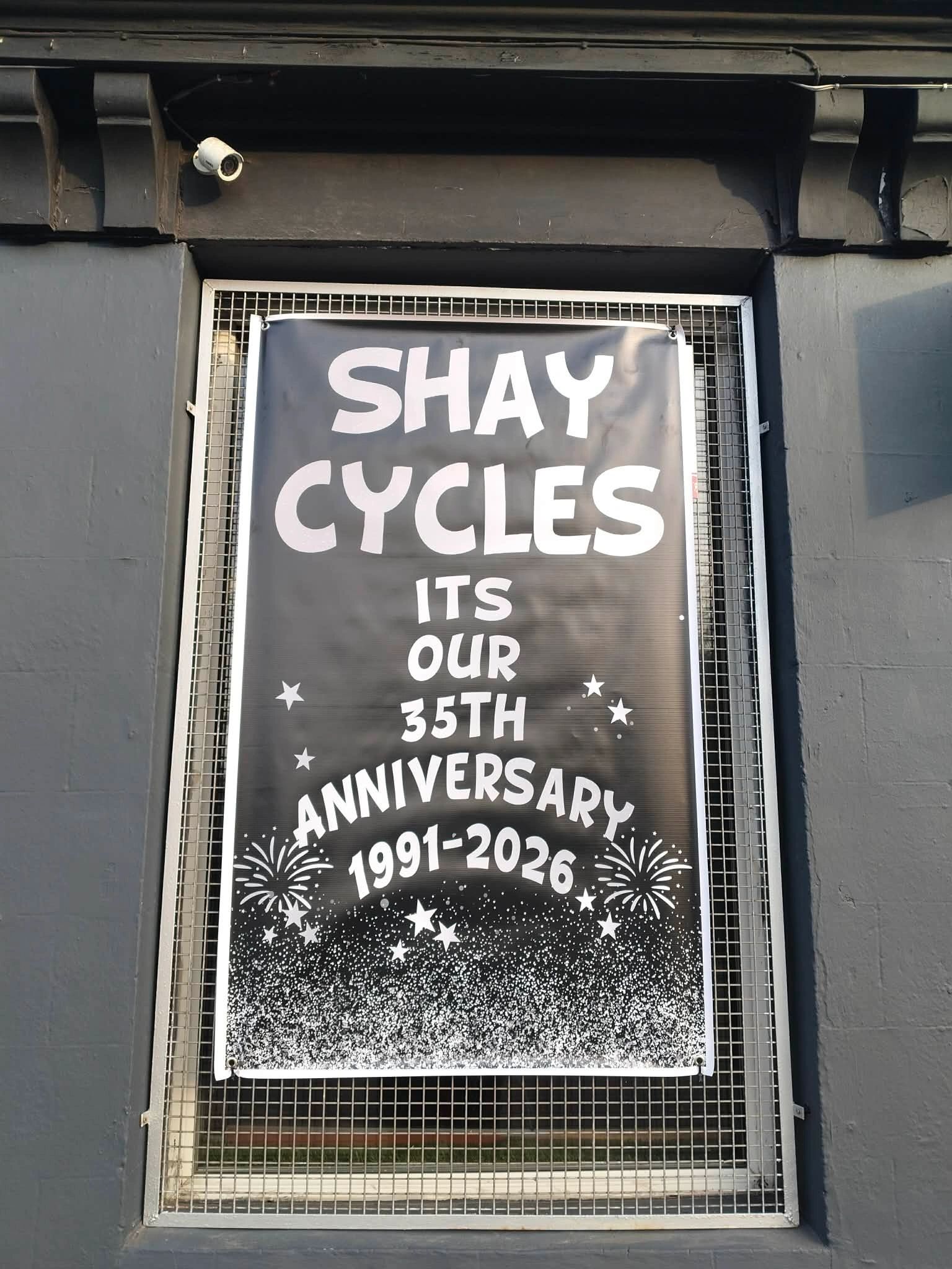 Hand-made window poster reading Shay Cycles, it's our 35th anniversary, 1991–2026